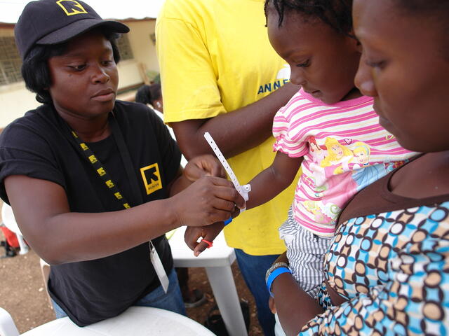 Ein IRC-Helferin hilft zwei jungen haitianischen Mädchen