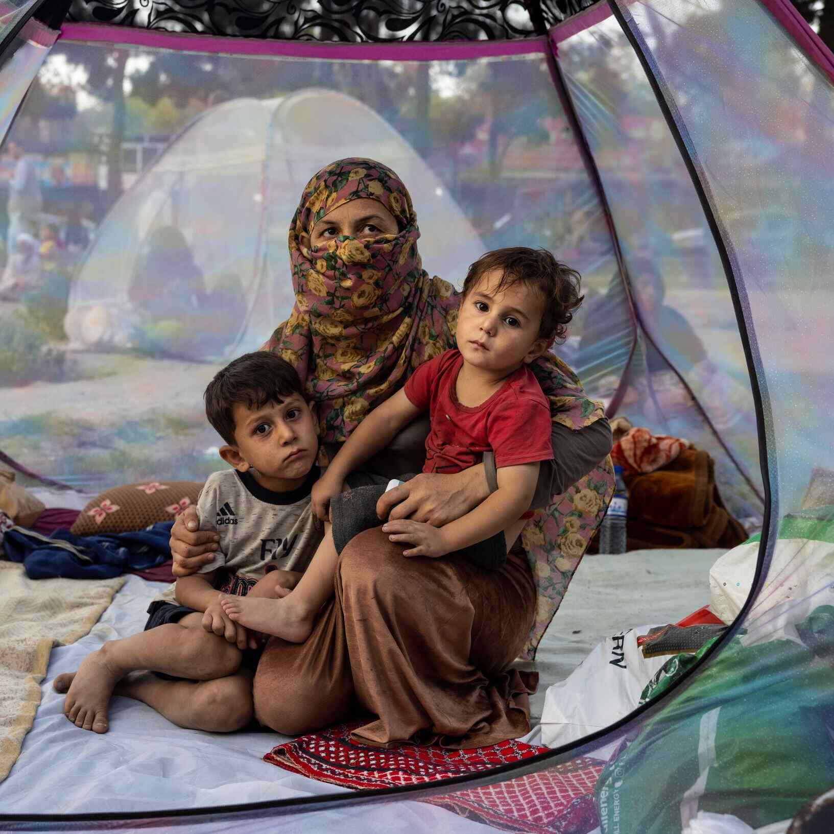 Afghanistan woman with children in tent